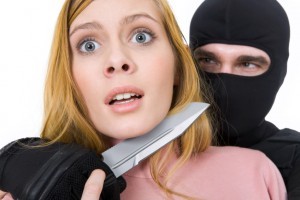 Image of pretty woman horrified trying to set herself free from criminal hands holding dangerous knife